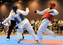 0982-RiderKOsKing9148.jpg: U.S. Army World Class Athlete Program martial artist Sgt. William Rider delivers a knockout kick to the ribs of Californian Cory King with 1 minute, 3 seconds remaining in the second round of their featherweight semifinal match at the 2009 U.S. National Taekwondo Championships July 5 at the Austin Convention Center in Texas. "In my 25 years of Taekwondo, I think that’s the second time I’ve ever seen a body shot knockout, and the first from a roundhouse kick,” WCAP Taekwondo coach David Bartlett said. “I have to give thanks to the strength and conditioning program of Master Sgt. Mike Mielke.” Photo by Tim Hipps, FMWRC Public Affairs